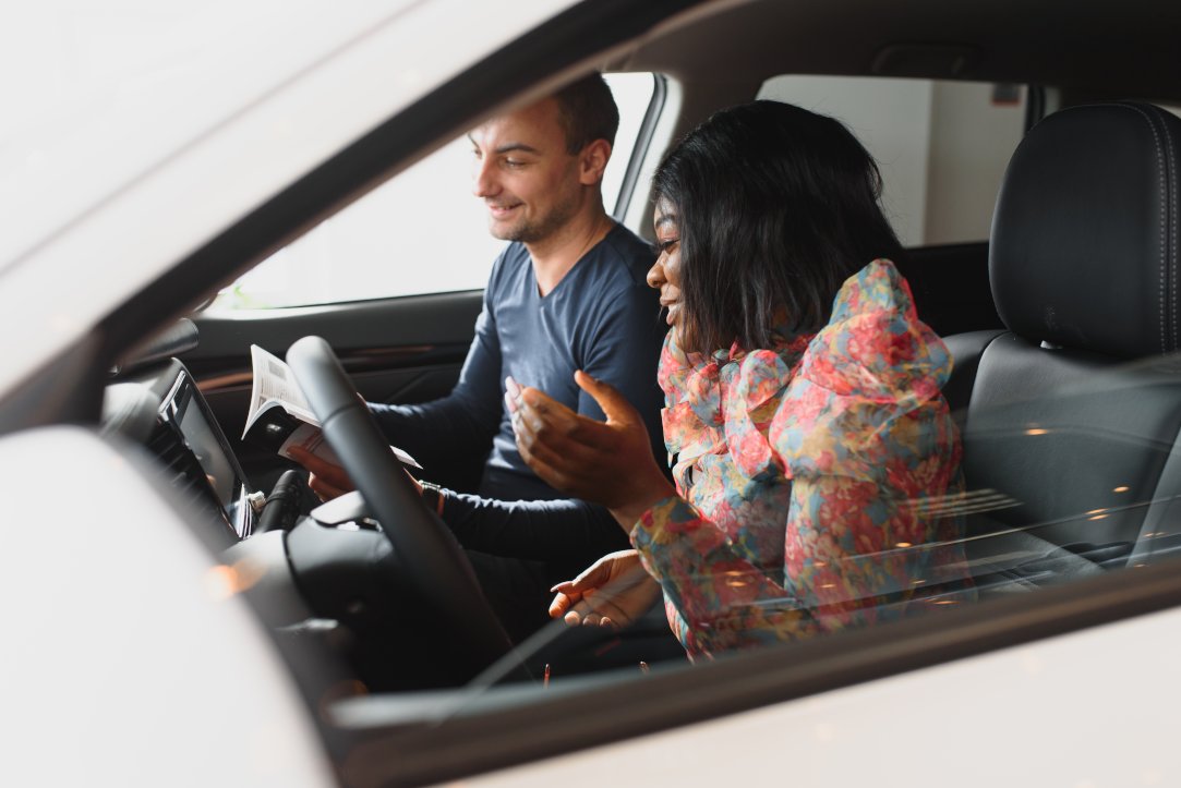 beautiful young african woman in driving lesson